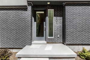 Doorway to property with brick siding