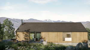 Rear view of property with a mountain view and a patio area