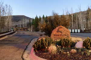 View of asphalt road featuring curbs and a mountain view