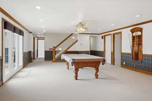 Recreation room with billiards table, light carpet, recessed lighting, crown molding, and a wainscoted wall