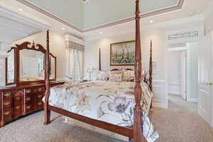 Bedroom with light colored carpet and crown molding