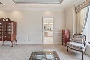 Sitting room with light carpet, ornamental molding, a wainscoted wall, a decorative wall, and wallpapered walls