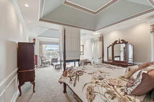 Carpeted bedroom with wallpapered walls, ornamental molding, a multi sided fireplace, recessed lighting, and wainscoting