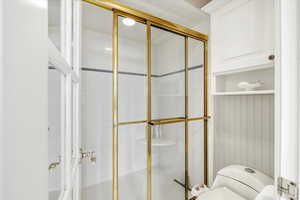 Bathroom with toilet and a stall shower