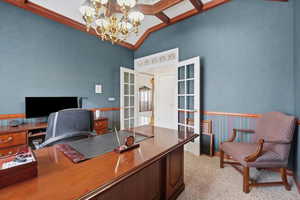 Office area with french doors, hanging lights, vaulted ceiling, and light colored carpet