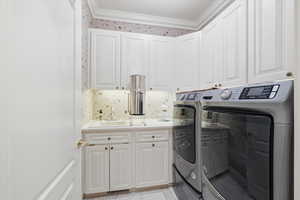 Laundry room with independent washer and dryer, cabinet space, and light tile patterned floors