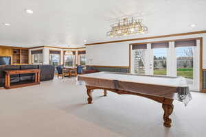 Game room featuring billiards table, recessed lighting, light carpet, a wainscoted wall, and crown molding