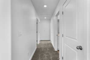 Hallway with carpet floors and recessed lighting
