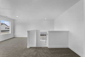 Corridor featuring an upstairs landing, carpet, and recessed lighting