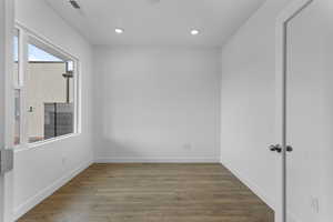 Unfurnished room with dark wood-type flooring and recessed lighting