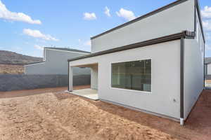 Back of property featuring a patio area and stucco siding