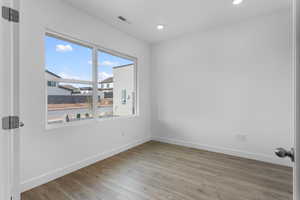 Spare room with light wood-style flooring and recessed lighting