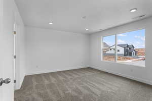 Empty room featuring carpet flooring and recessed lighting