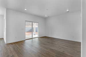 Unfurnished room with recessed lighting and dark wood-type flooring