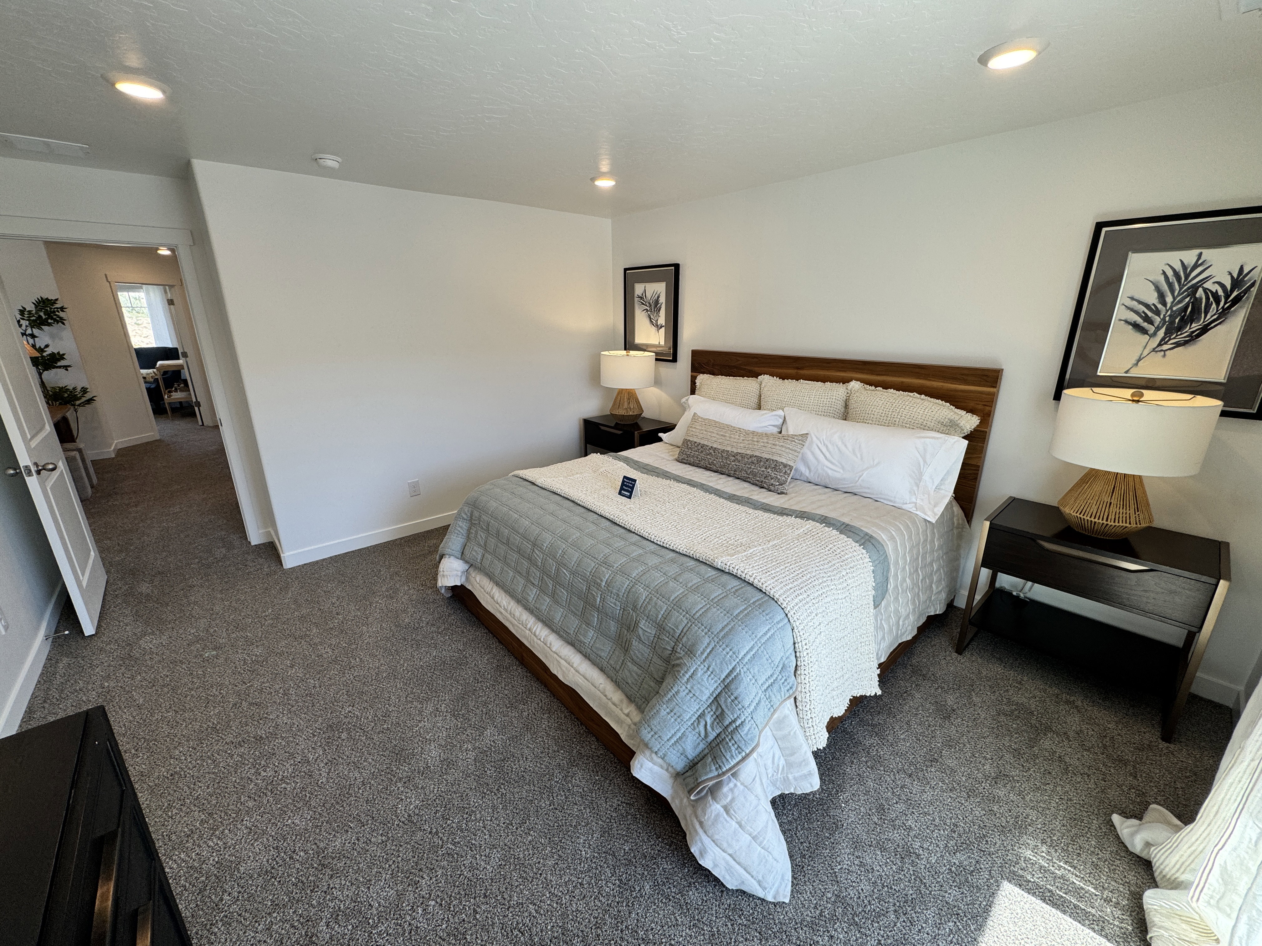 Carpeted room with recessed lighting and a wood-finish headboard
