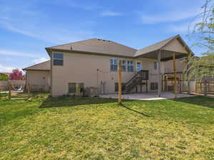 Back of house featuring a patio, a fenced backyard, and roof with shingles