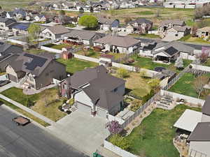 Aerial view of property and surrounding area featuring nearby suburban area