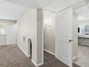 Bonus room featuring carpet and a textured ceiling