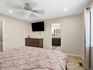 Bedroom featuring a ceiling fan, light wood-style floors, connected bathroom, and recessed lighting