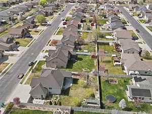 Aerial view of property and surrounding area with nearby suburban area