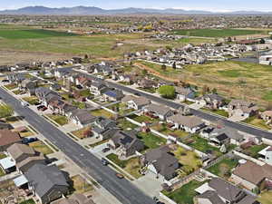 Aerial overview of property's location with nearby suburban area and a mountainous background