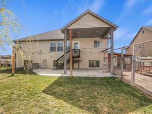 Back of property featuring a patio area, a fenced backyard, and a gate