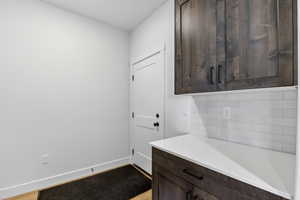 Laundry area featuring baseboards