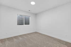 Unfurnished room featuring baseboards and carpet