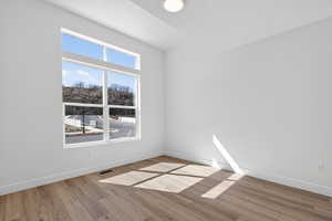 Spare room with light wood-type flooring and baseboards