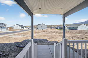 View of yard with covered porch and a residential view