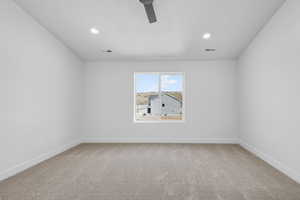 Spare room with light colored carpet, a ceiling fan, recessed lighting, and a textured ceiling