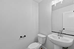 Half bath with toilet and a sink