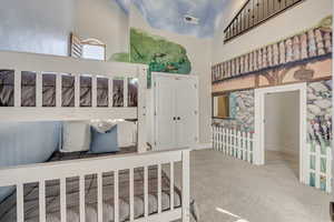 Tall ceilings and cozy play area, with loft overlook from upper playroom next door