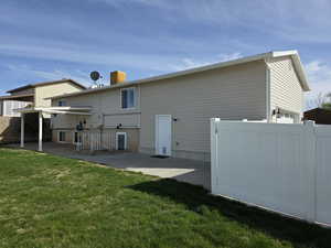 Rear view of property featuring a patio area