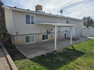 Rear view of property with a patio area and a gate