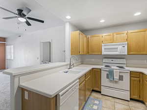 Kitchen with white appliances, light countertops, a peninsula, ceiling fan, and recessed lighting