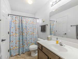 Full bathroom with vanity and a shower with shower curtain