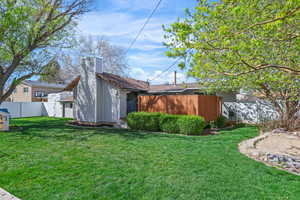Rear view of property featuring a chimney