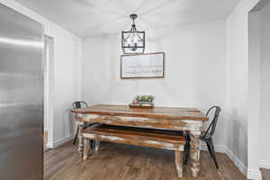 Dining room featuring wood finished floors and a chandelier