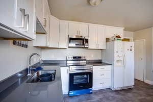 Kitchen with stainless steel appliances and white cabinets