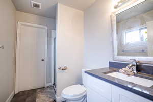 Full bathroom featuring a shower stall and vanity