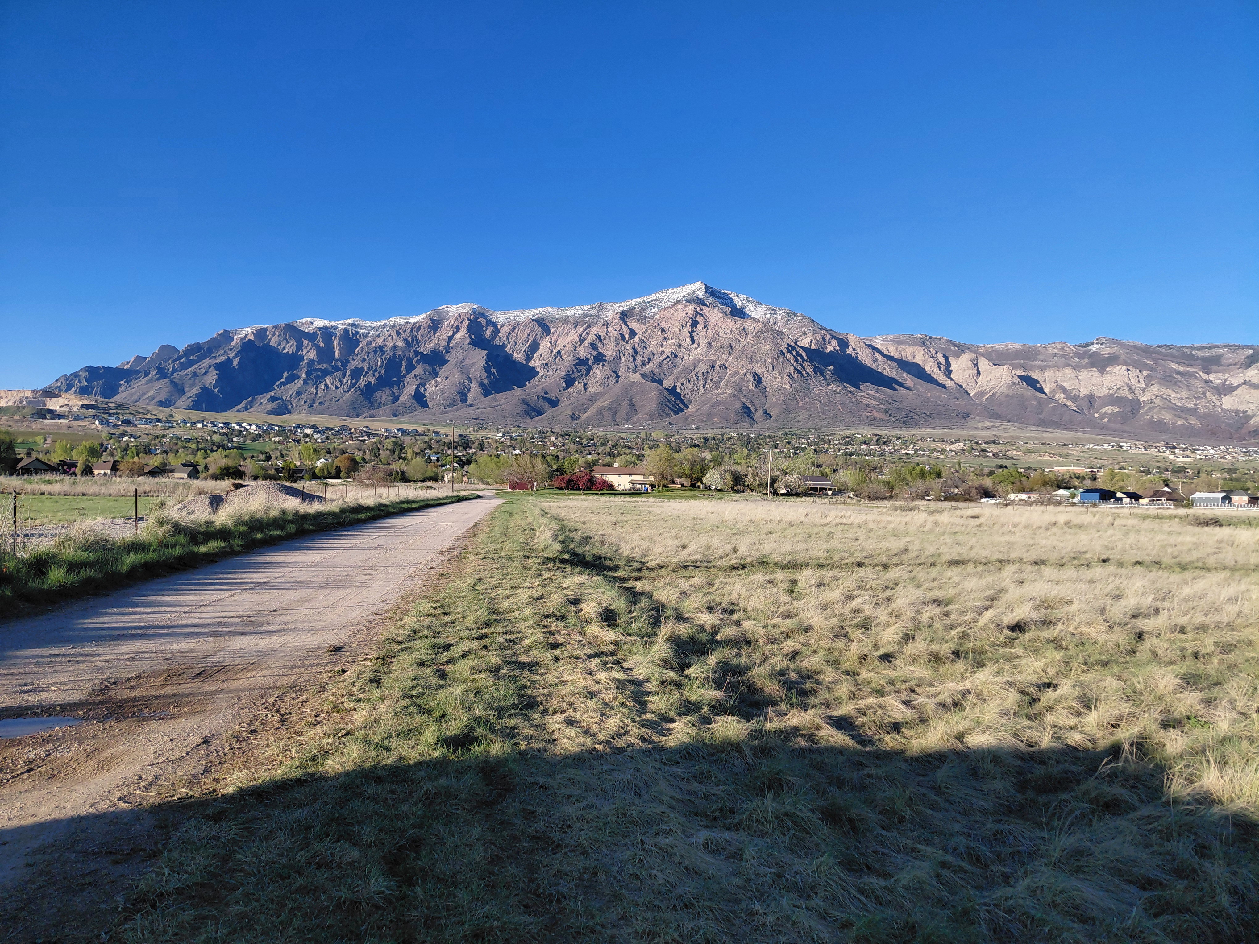 View of home and property looking North down long dirt driveway from Hwy 89