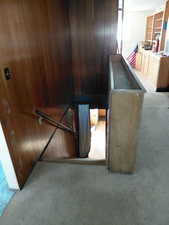 Stairs down to basement with carpet