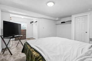Bedroom featuring light colored carpet and baseboards