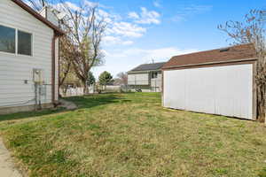 View of yard featuring a storage unit