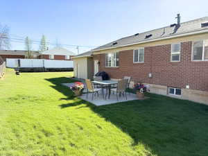 Back of house featuring a patio and brick siding ehhanced photo