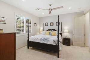 Bedroom featuring light carpet, ceiling fan, and recessed lighting