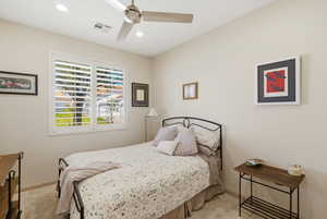 Bedroom with light carpet, a ceiling fan, and recessed lighting