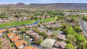 Aerial view of residential area with a water and mountain view and a golf club