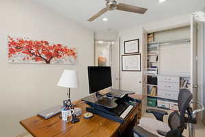 Office space with a ceiling fan and recessed lighting